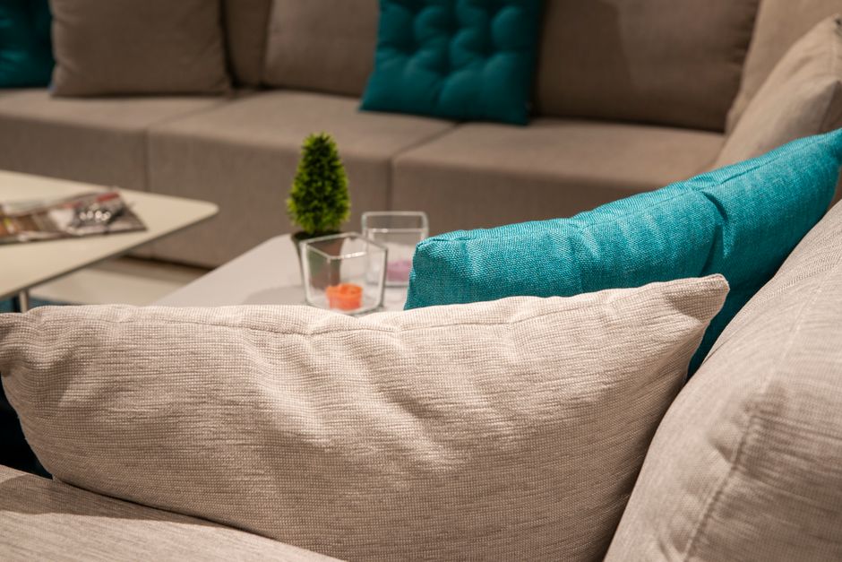 Stylish indoor living room with a modern sofa, colorful pillows, and home decor.